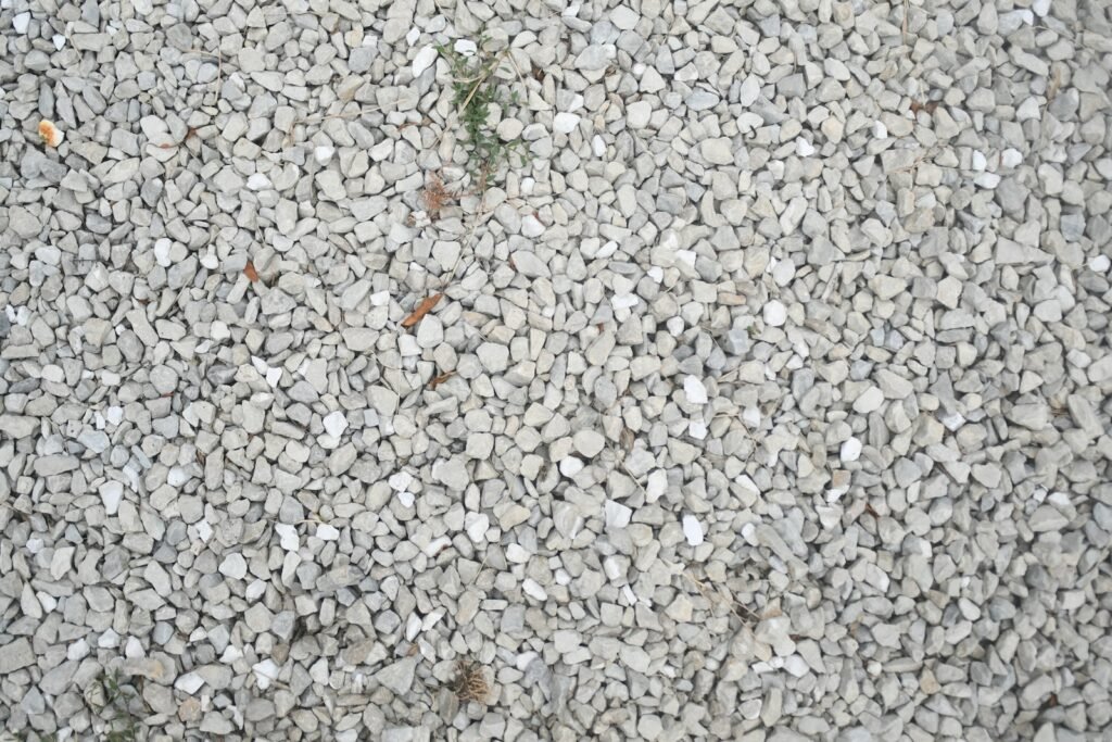 A textured background of small, light gray pebbles.